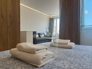 two towels sitting on a bed in a room at Penthouse Mentidero Loft Grupo AC Gestión in Cádiz