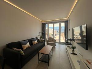 a living room with a couch and a chair at Penthouse Mentidero Loft Grupo AC Gestión in Cádiz