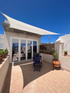 a patio with two chairs and a white canopy at Penthouse Mentidero Loft Grupo AC Gestión in Cádiz