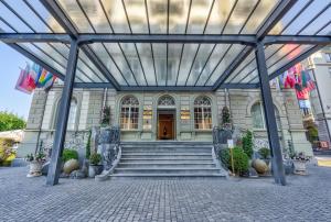 a building with a staircase leading to a door at Grand Hotel National Luzern in Luzern