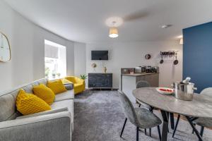 a living room with a couch and a table at Exquisite flat in Sheffield in Sheffield