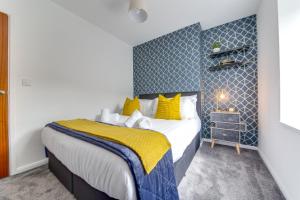 a bedroom with a large bed with yellow pillows at Exquisite flat in Sheffield in Sheffield