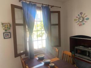 a dining room with a table and a window at Eva's house in Mithymna