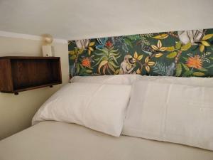 a bedroom with a bed with a floral head board at Un rifugio bohémien in Turin
