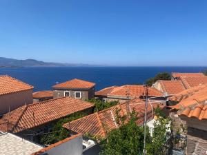 a view of roofs of houses and the ocean at Eva's house in Mythimna