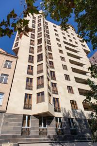 um edifício de apartamentos branco e alto com janelas em hotelise I Minas Apartment em Yerevan