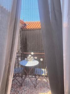 a patio with a table and chairs on a balcony at Eva's house in Mythimna +7 photos