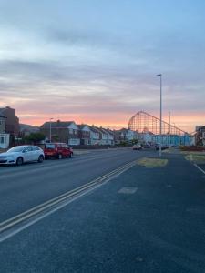 a street with cars parked on the side of the road at Crosby Hotel in Blackpool