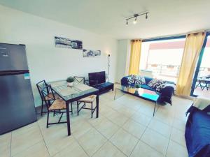 a living room with a table and a couch at Casa Bella Vista - pool - WiFi in Caleta De Fuste