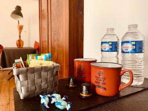 a table with two cups and two bottles of water at 47 Les Chimères in Lussant