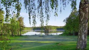 a golf course with a view of a lake at Hotel Fritza - tidigare "Hotel Fritzatorpet" in Olofström