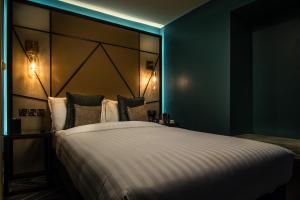 a bedroom with a large bed with a large headboard at Seven Hotel in Southend-on-Sea