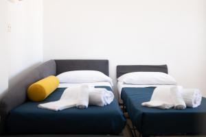 two beds sitting next to each other in a room at Calanca Apulian Residence in Torre Santa Sabina