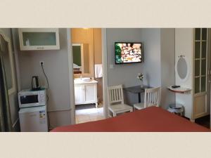 a living room with a sink and a tv on the wall at Hotel Taksim Home in Istanbul