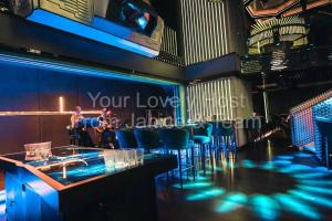 a bar with blue lights in a restaurant at #5 KLCC Platinum Suites (Face Suites) 2BED 2BATH in Kuala Lumpur