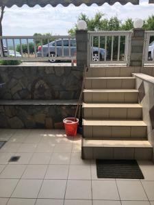 a set of stairs with a red bucket in a parking lot at AZALEA HOTEL in Sarti