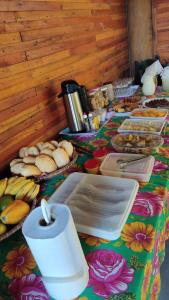 a table topped with lots of different types of food at Pousada Maia in Itaúnas