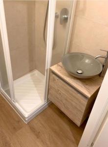 a bathroom with a glass sink and a shower at Appartamento centro storico Nuovo e Ristrutturato in Pesaro