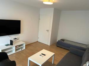 a living room with a couch and a tv at 70 square m with balcony+parking+AC in Ljubljana
