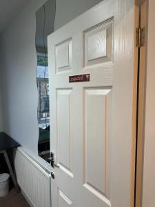 a white door with a sign on it at Ecclesall Suites in Nether Edge