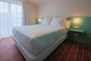 Terra Aurea Aparthotel客房内的一张或多张床位