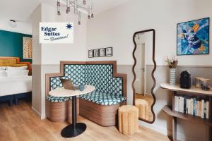 a room with a chair and a table with a laptop at Edgar Suites Montmartre - Paul Albert in Paris