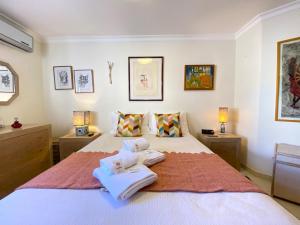 a bedroom with two towels on a bed at Vilamoura Central 7 With Pool by Homing in Vilamoura