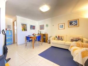 a living room with a couch and a table at Vilamoura Central 7 With Pool by Homing in Vilamoura