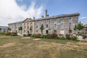 a large stone building with a yard in front of it at Luxury 2 bed Apartment in historic Royal William Yard in Plymouth