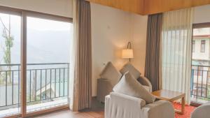 a living room with a view of a balcony at Days Inn by Wyndham Gangtok Tadong in Gangtok