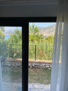 a room with a window with a view of the mountains at Gala Selimiye in Selimiye