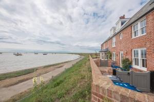 a brick house with a view of the water at Quay View in Woodbridge