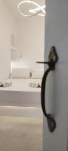 sypialnia z białym łóżkiem i sufitem w obiekcie Cozy Now w mieście Tinos