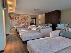 a row of couches in a living room at Vitalhotel Bad Birnbach in Bad Birnbach +41 photos