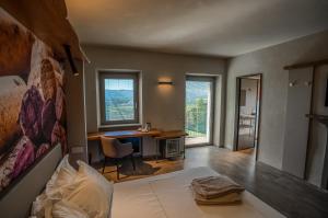 a bedroom with a bed and a desk with a chair at Il Vigneto in Roddi