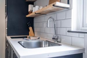 a kitchen counter with a sink in a kitchen at Goodstay Lodges by Urban Space in Barry