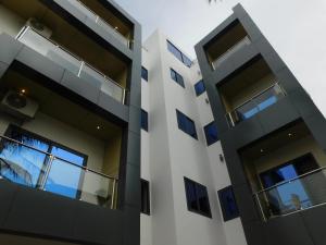 an exterior view of a building with blue windows at Résidence Bouba Bamako in Bamako