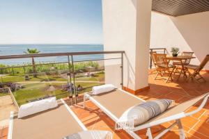 a room with a balcony with a view of the ocean at Casares del Mar D1 9 in Casares