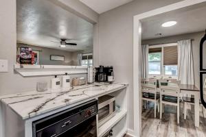 a kitchen with white counters and a counter top at Kiki's Place half mile From OSU STADIUM in Stillwater