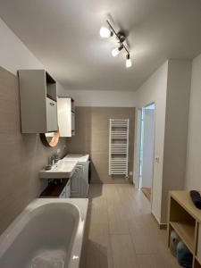 a bathroom with a large tub and a sink at Wiener Townhouse Schönbrunn in Vienna
