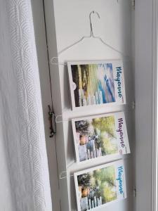 a door with three pictures on the wall at La maison de Miffy in La Chapelle du Chêne +2 photos
