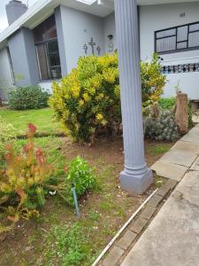 a pole in front of a house with flowers at 9 on Oostersee in Cape Town