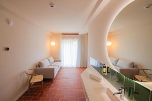 a room with two couches and a window at Terra Aurea Aparthotel in Salou