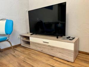 a flat screen tv sitting on a wooden entertainment center at Roggendorf in Mechernich