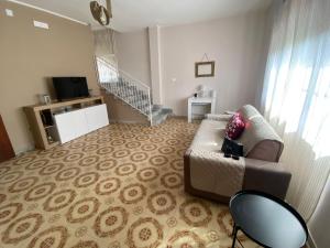 a living room with a couch and a staircase at villa aglaia30 in Capaccio-Paestum