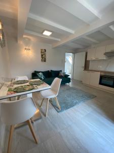 a kitchen and living room with a table and chairs at Mountain view in Bohinj in Bohinj