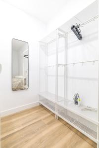 a bathroom with white shelves and a mirror at Arturo Soria Apartments3 in Madrid