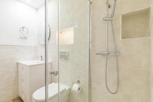 y baño con ducha, aseo y lavamanos. en Arturo Soria Apartments3, en Madrid