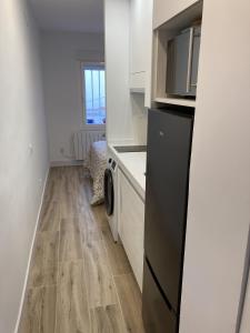 a kitchen with a washer and dryer in a room at Plaza Castilla Apartments in Madrid