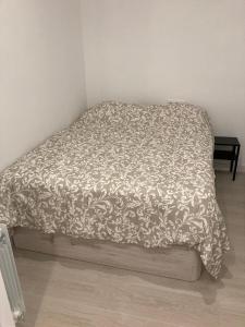 a bed with a comforter on it in a room at Matadero Apartments 3 in Madrid +8 photos